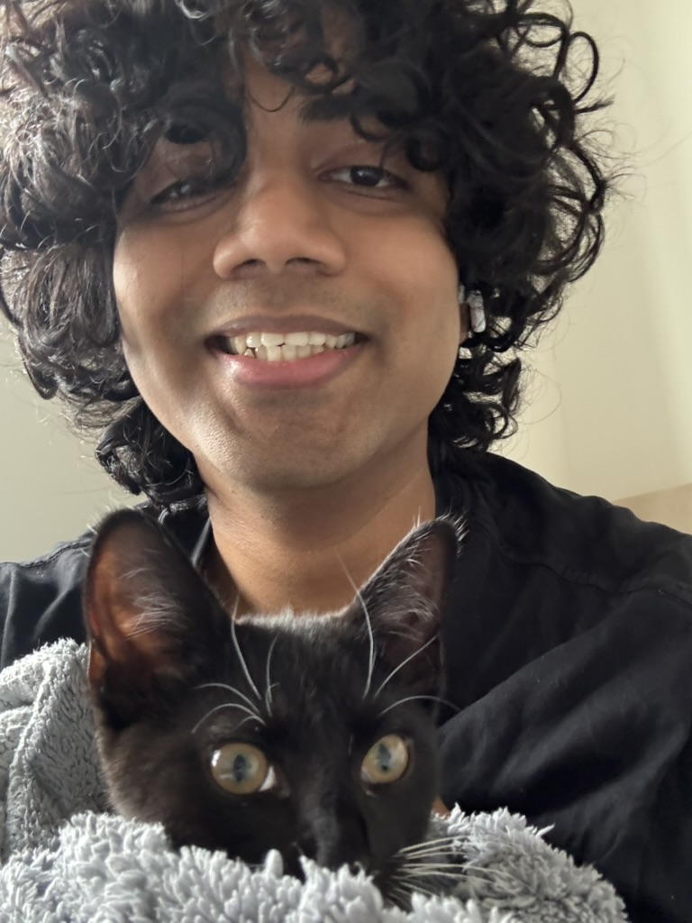 Akash holding a black cat