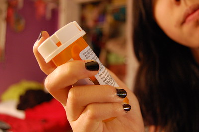 woman holding pill bottle