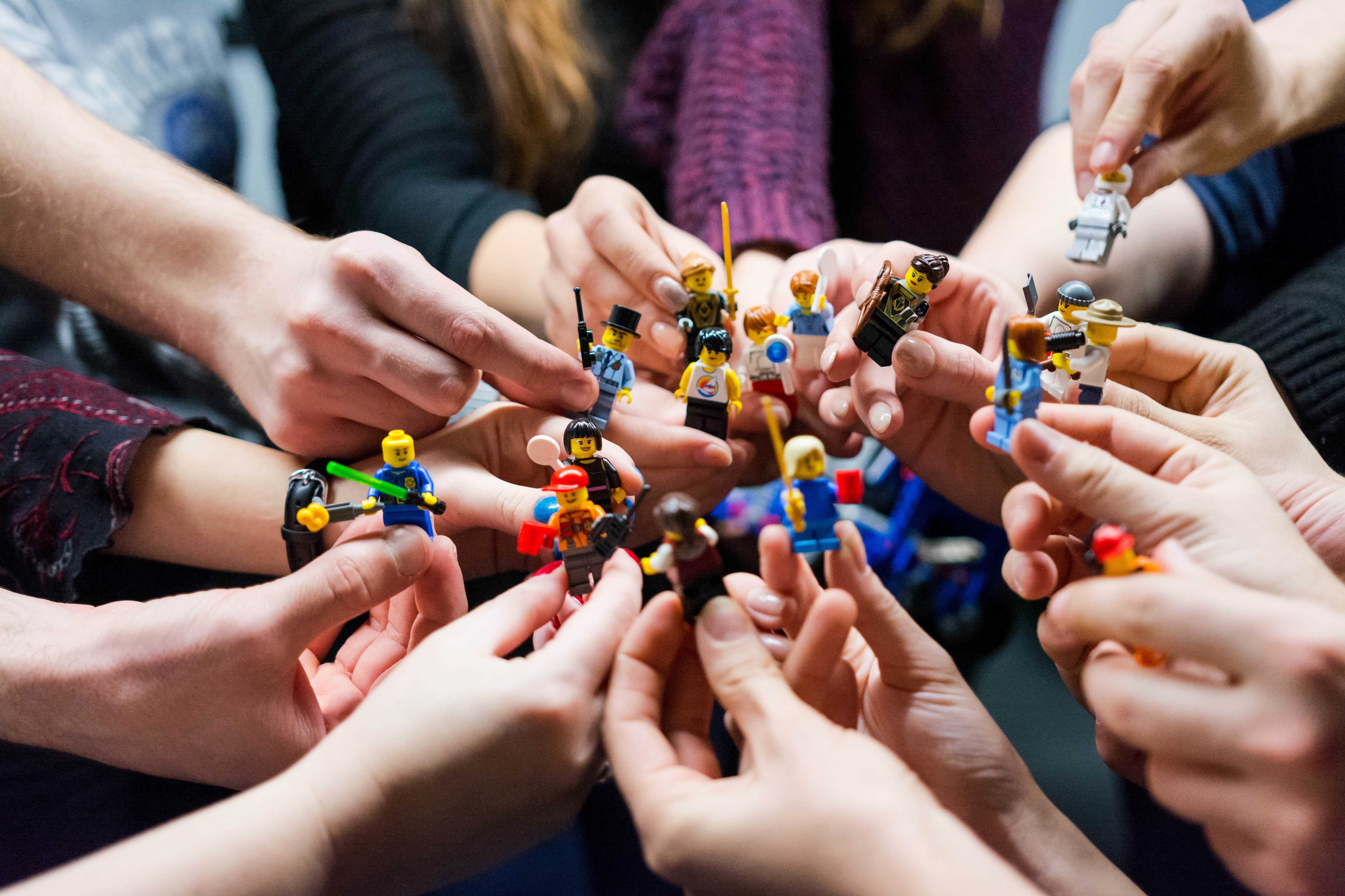 group of people holding legos