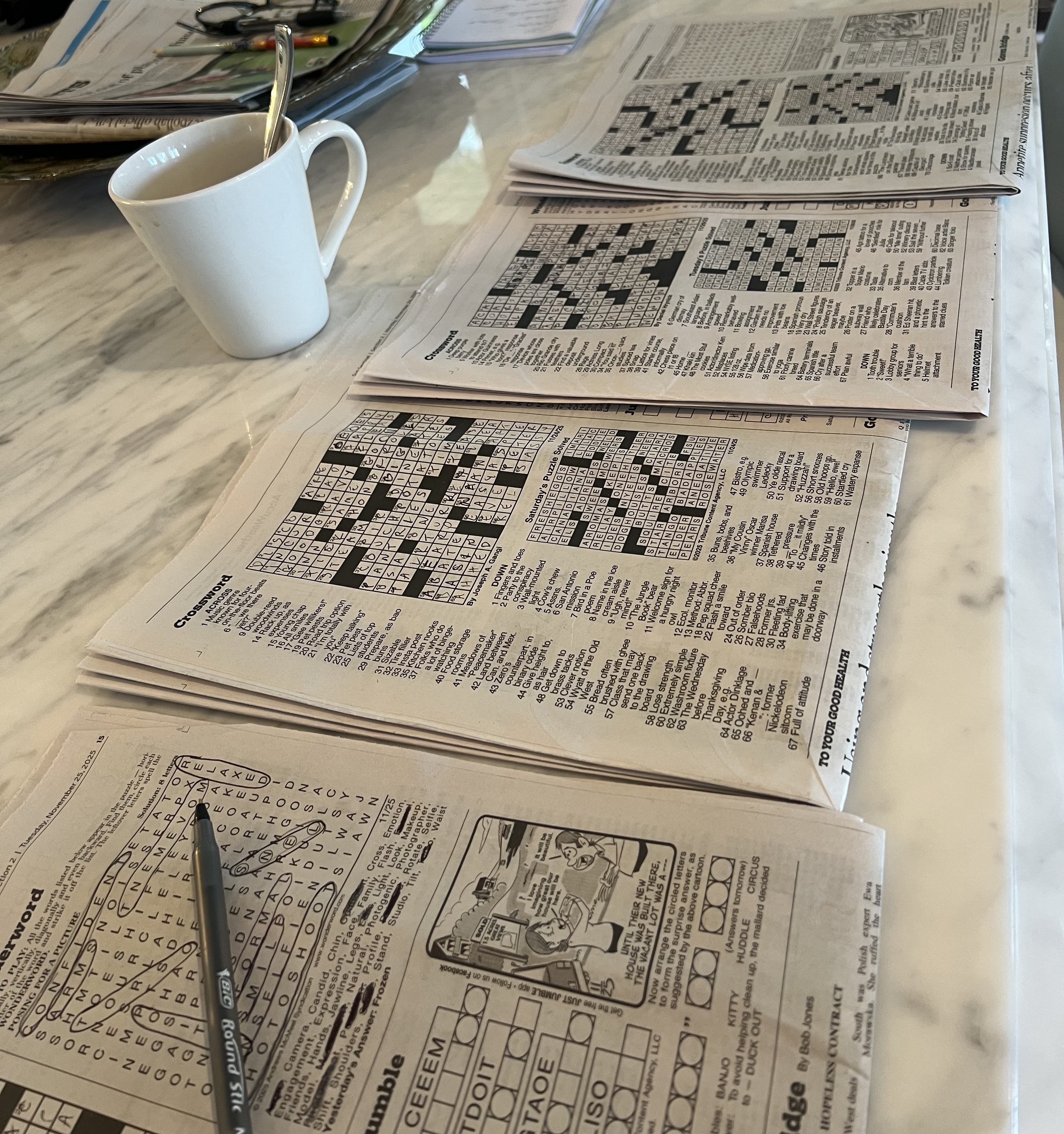 Splayed crossword puzzles on a counter
