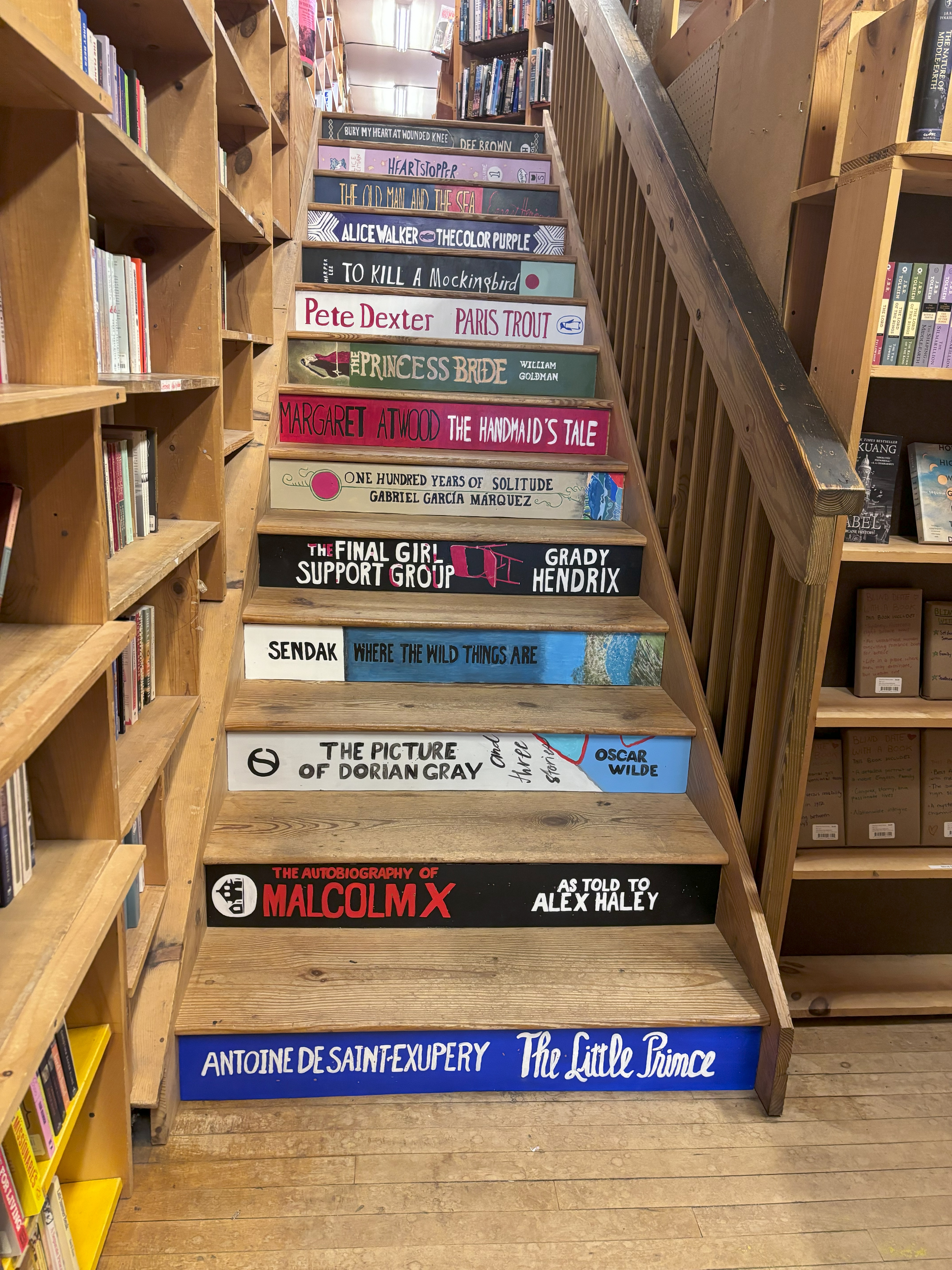 Stairs with book covers painted on front side