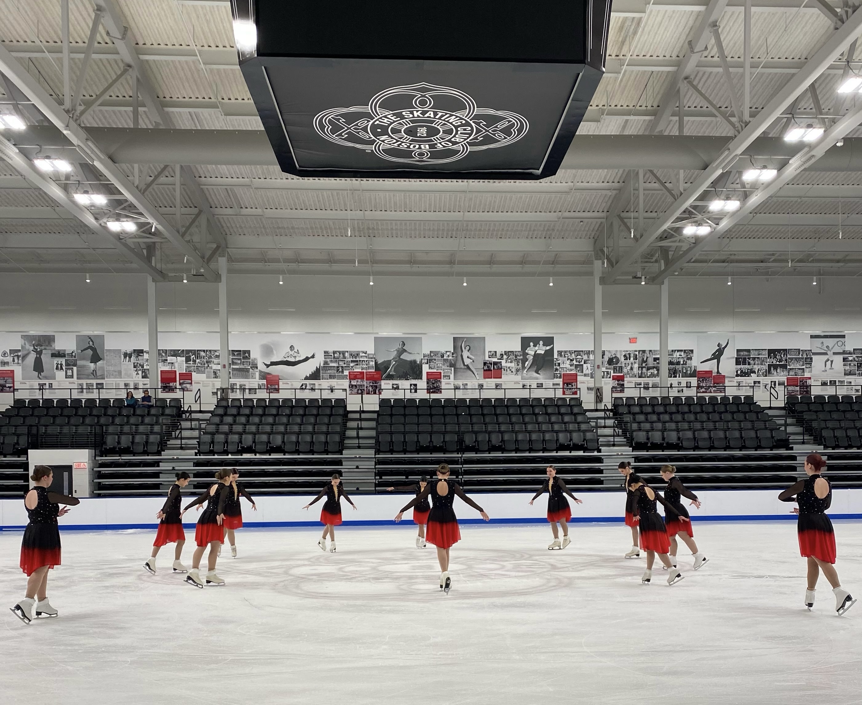 12 skaters in starting position for synchronized ice skating program