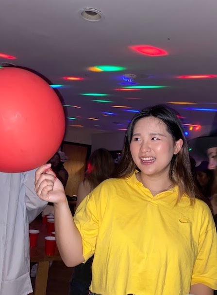 Portrait picture of Kelly holding onto a balloon