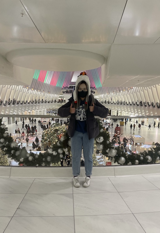 A girl in the Oculus shopping mall around Christmas season.