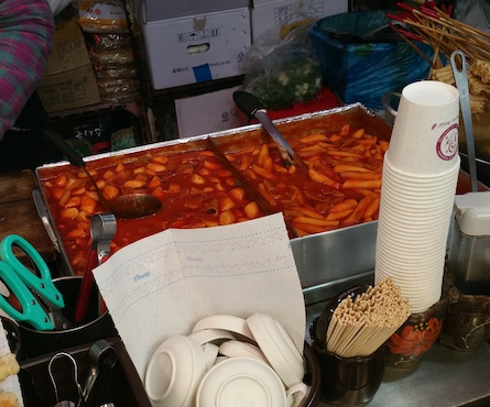 Red-hot spicy rice cakes in the process of being made in a typical Korean street vendor